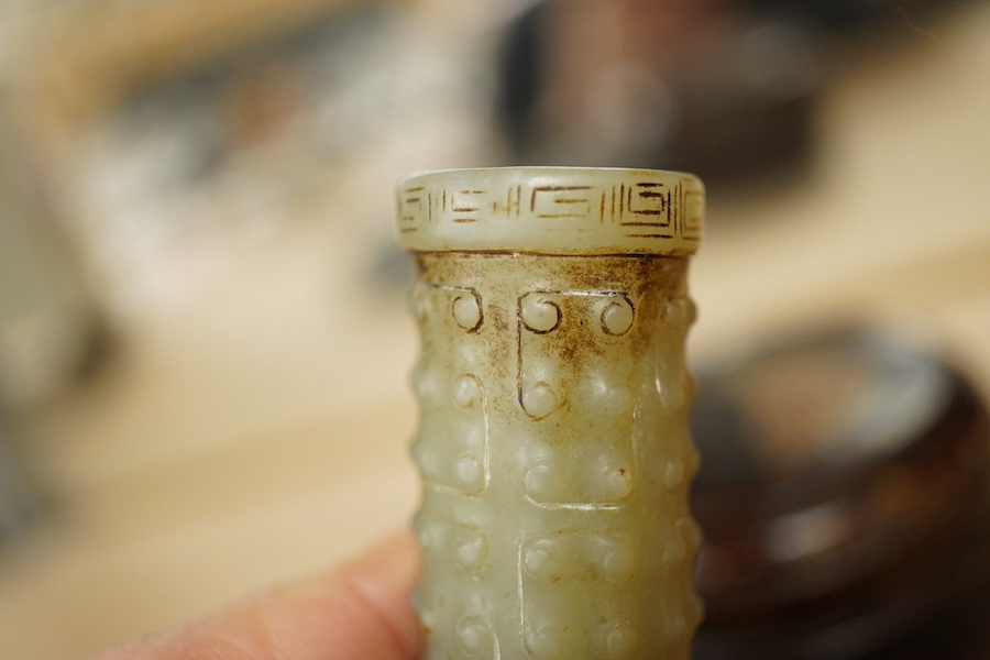 A Chinese silvered bronze mirror, a lacquer box and a jade cylindrical bead, largest 15cm diameter. Condition - fair to good